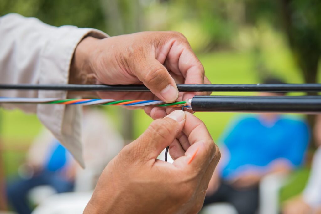 technicians are installing optic fiber